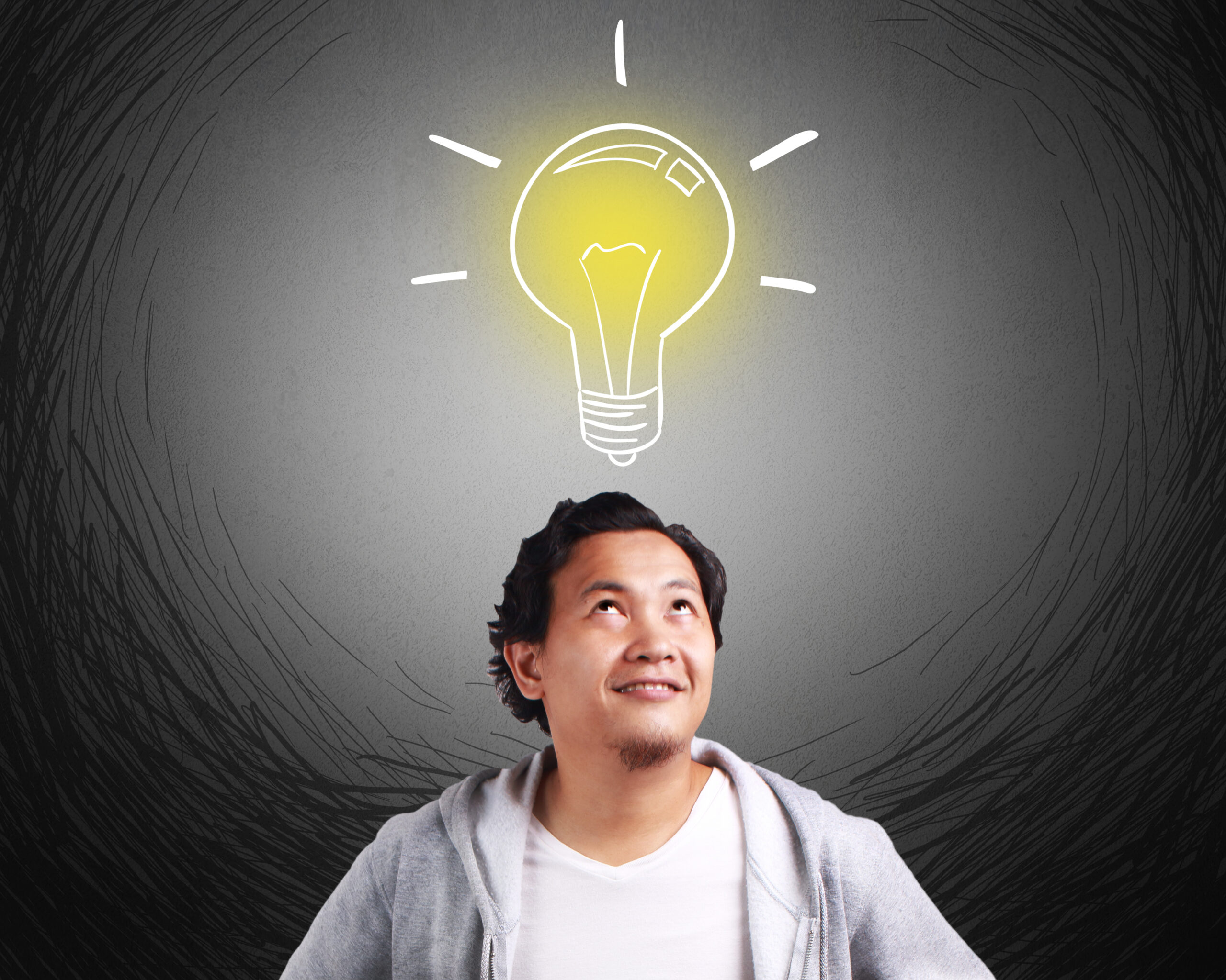 Lit lightbulb above person's head.