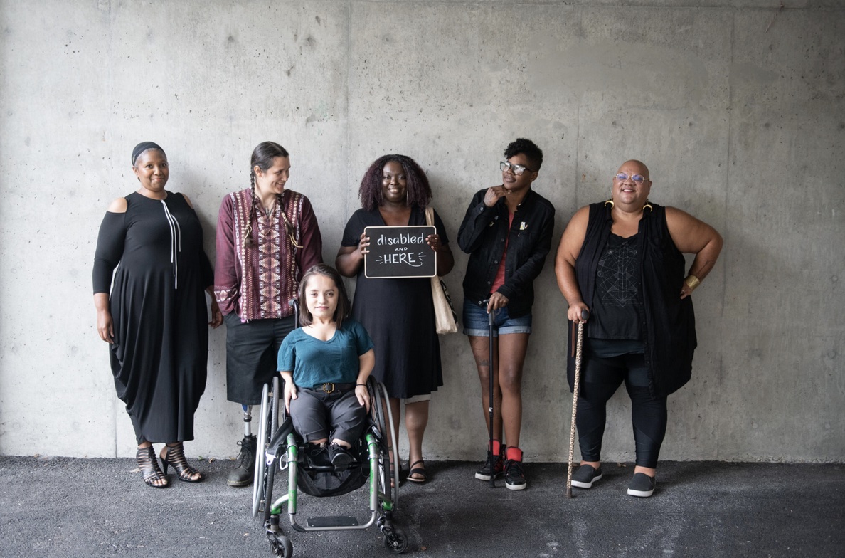 Disabled people in front of concrete wall