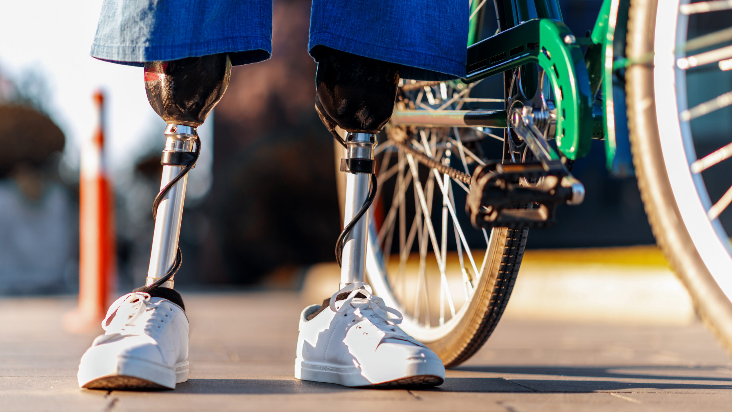 Person with prosthetic legs next to their bike