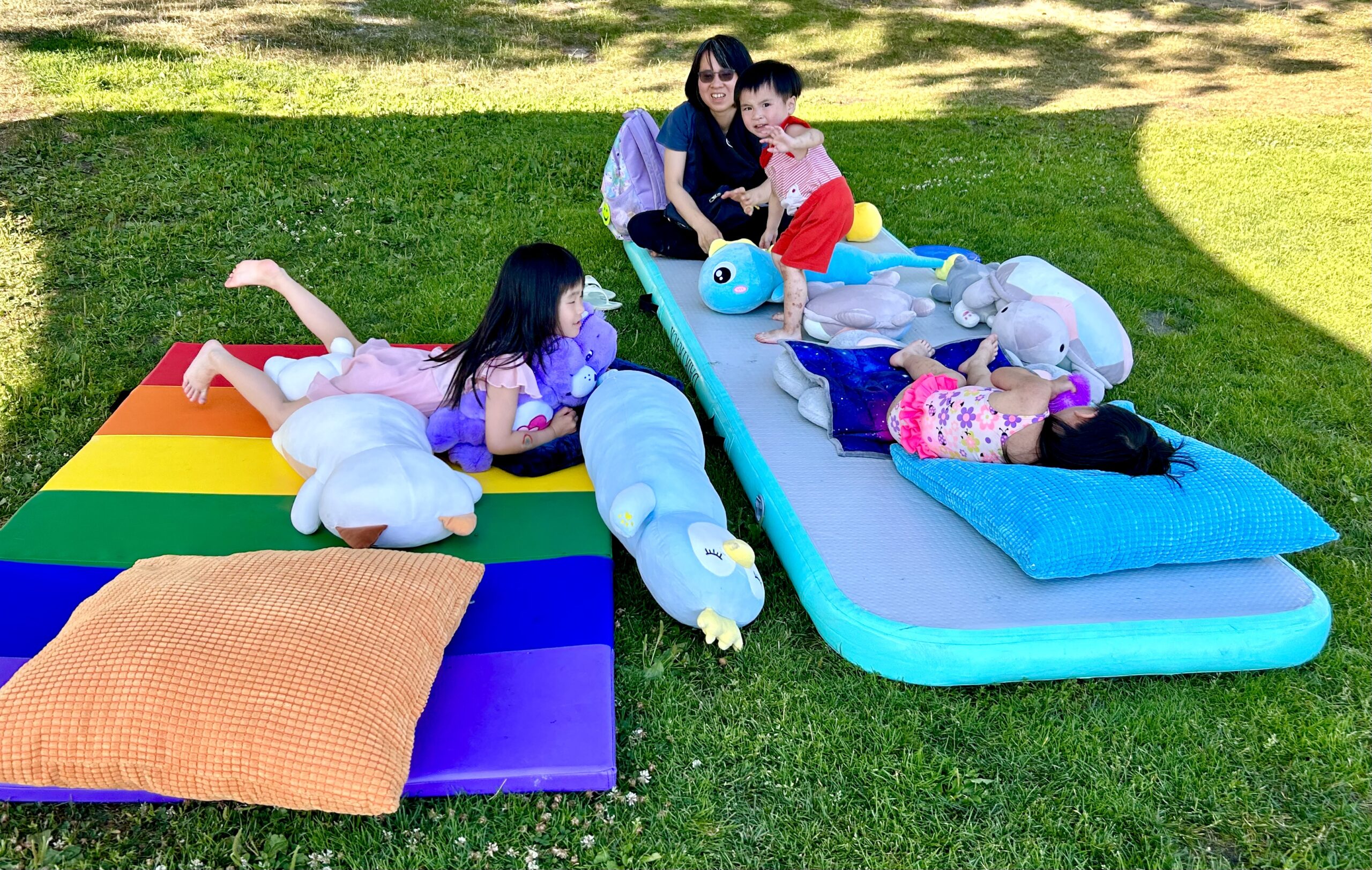 Family of 4 playing outside at low sensory space.