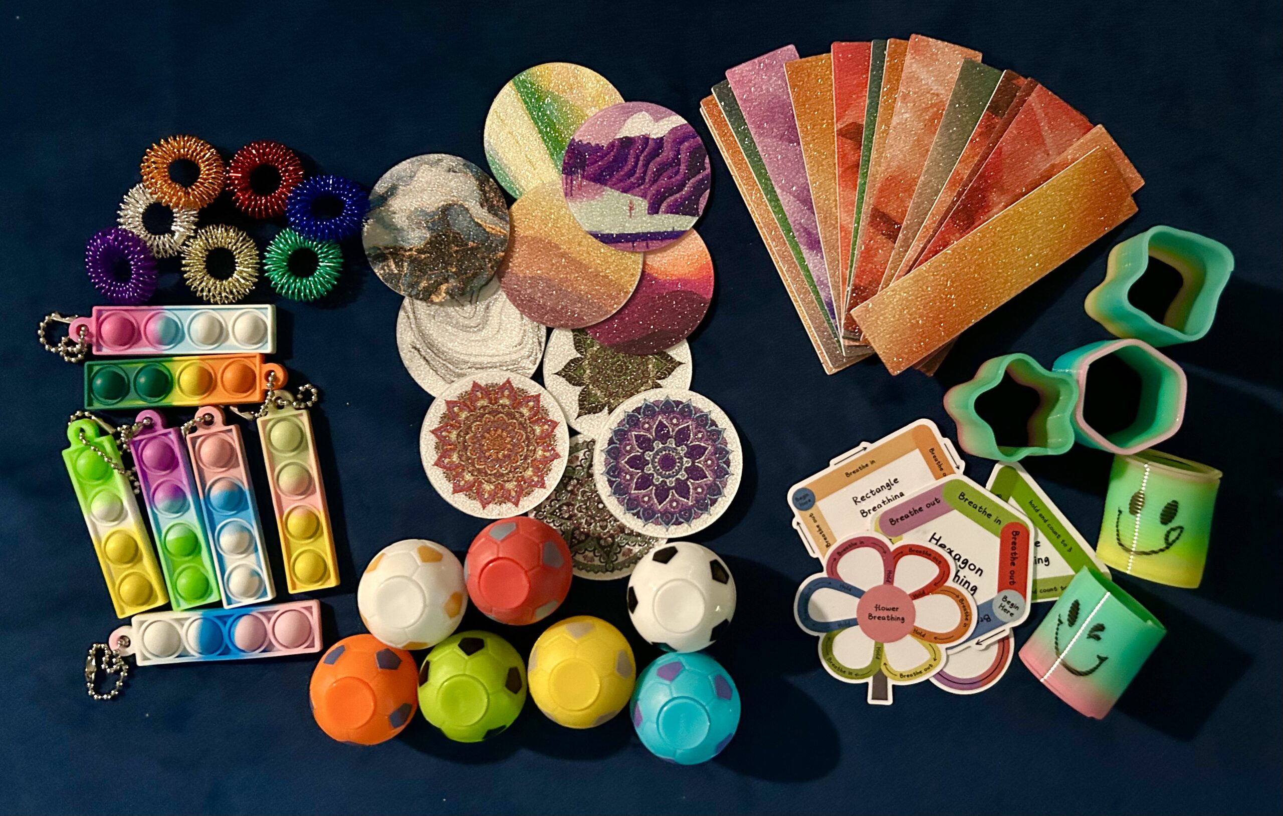 A collection of sensory items on blue cloth.