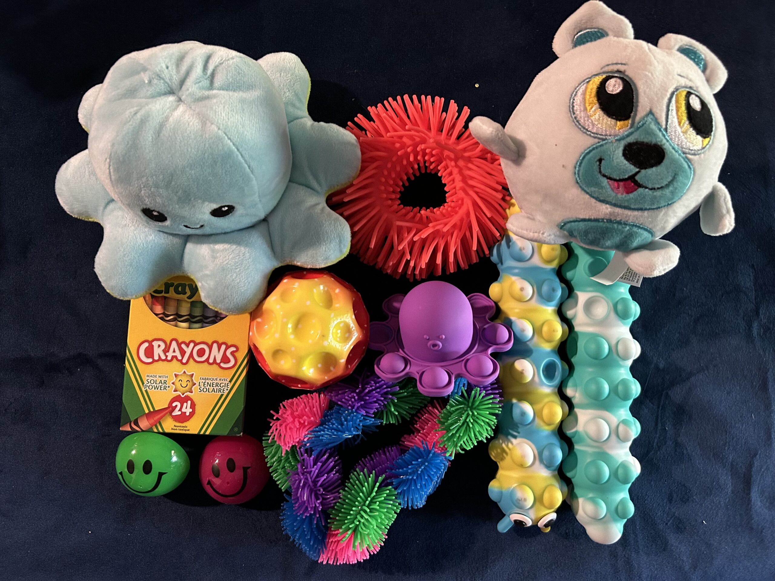 Medium sensory items on blue cloth.